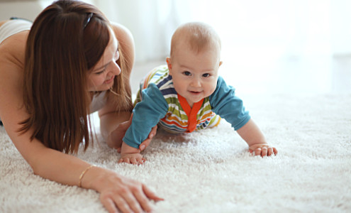 Vivid Cleaning Services - Cairns carpet cleaners showcasing steam cleaned carpet with mother and baby